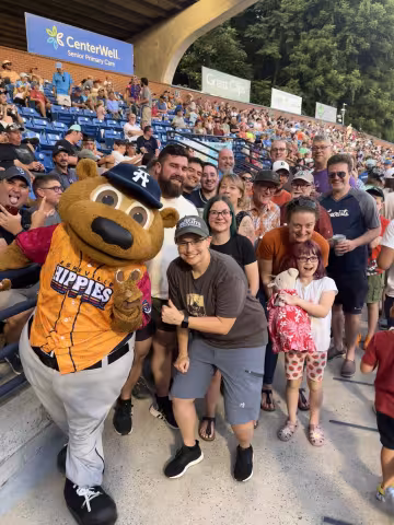 Group photo with the Asheville Tourists bear mascot.