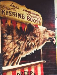 Mural of a bear in a kissing booth