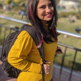 Surabhi Gokte Smiling Towards The Camera In A Vibrant Yellow Sweater